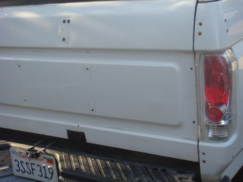 1992 Ford Bronco - Rear view of a white pickup truck's tailgate, showing a California license plate.