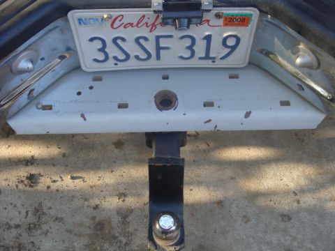 1992 Ford Bronco - The rear of a vehicle shows a trailer hitch and a California license plate.