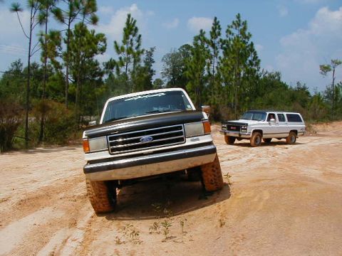 1990 Ford Bronco - This 1990 Ford Bronco is captured in a 3/4 front view while navigating an off-road trail.