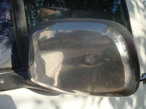 1992 Ford Bronco - Close-up of the chrome side mirror on a 1992 Ford Bronco.