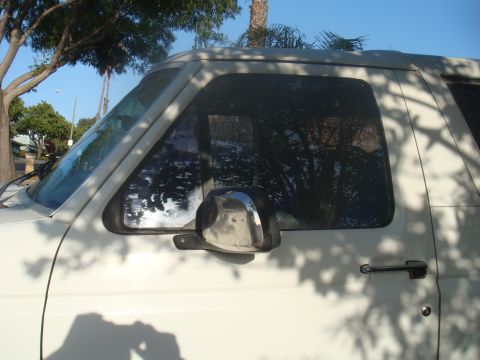 1992 Ford Bronco - Side view of a 1992 Ford Bronco, showing the door and window details.