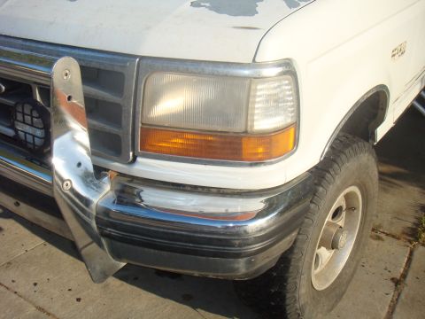 1992 Ford Bronco - This 1992 Ford Bronco shows its front corner with a chrome bumper and a brush guard.