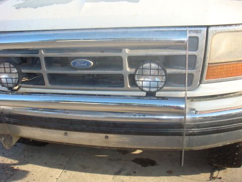1992 Ford Bronco - Front view of a 1992 Ford Bronco, showing the grille, Ford badge, and fog lights.