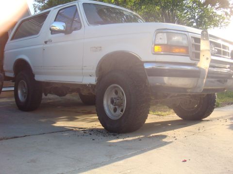 1992 Ford Bronco - This 1992 Ford Bronco features a chrome bull bar and oversized tires, suggesting off-road capability.
