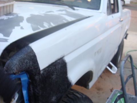 1992 Ford Bronco - A white Ford truck, possibly a 1992 model, is shown with its front fender undergoing some work.