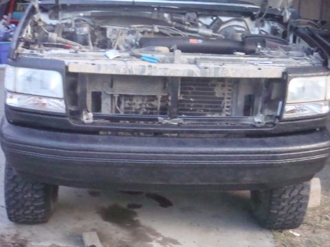 1992 Ford Bronco - Front view of a 1992 Ford Bronco with the hood open, revealing the engine compartment.