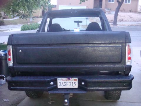 1992 Ford Bronco - This Ford Bronco is parked in a driveway, showing its rear end and license plate.