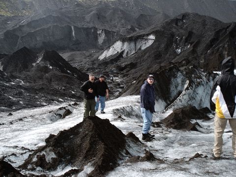 1996 Ford Bronco - People explore a glacier covered in black ash and ice.