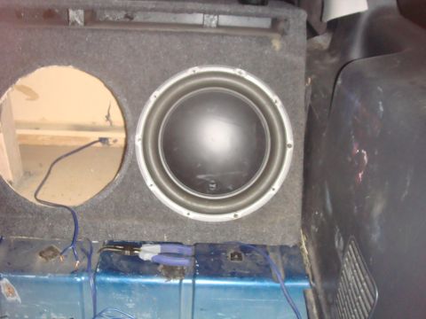 1992 Ford Bronco - Subwoofer and enclosure installed in a vehicle's cargo area.