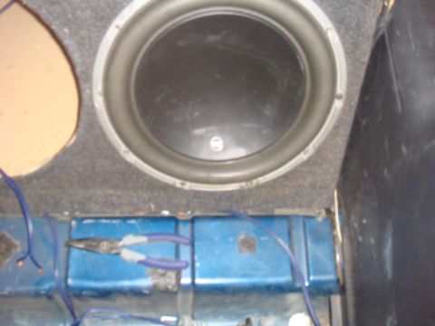1992 Ford Bronco - A car's interior shows a subwoofer installation with wiring and tools.
