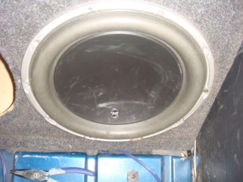 1992 Ford Bronco - Subwoofer installed in vehicle, showing wiring and mounting hardware.