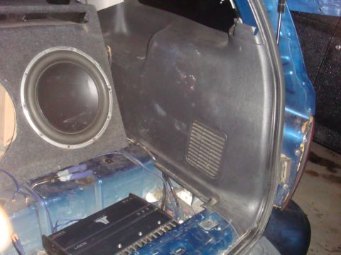 1992 Ford Bronco - The rear cargo area of a vehicle is shown with aftermarket audio equipment installed.