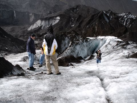 1996 Ford Bronco - Explorers navigate a vast, icy landscape with dramatic, dark mountain formations towering behind them.