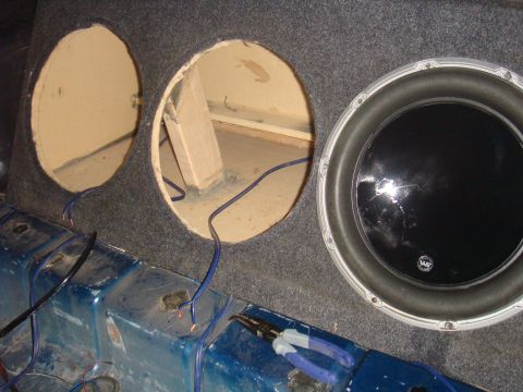 1992 Ford Bronco - Installing a subwoofer in a vehicle's interior, showing the speaker enclosure and wiring.
