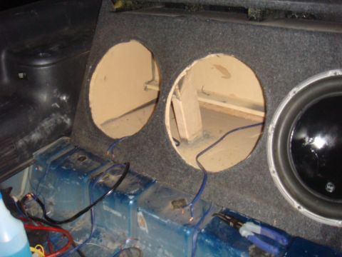 1992 Ford Bronco - Custom subwoofer box installed in the rear of a vehicle, with wiring and speaker components visible.