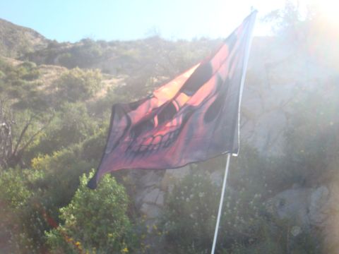 1992 Ford Bronco - A flag with a skull design waves in the breeze against a sunny, outdoor backdrop.