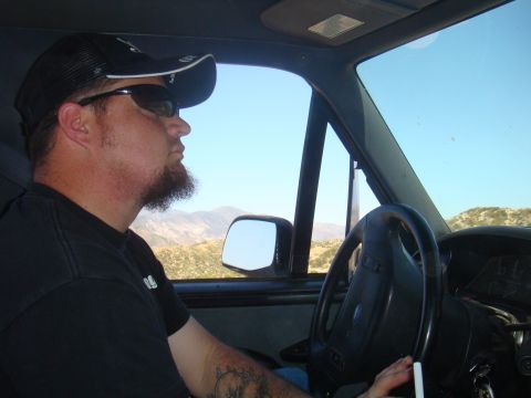 1992 Ford Bronco - A man drives a 1992 Ford Bronco through a mountainous, arid landscape.