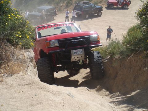 1992 Ford Bronco - This modified 1992 Ford Bronco tackles a challenging off-road course alongside other vehicles.