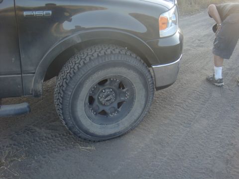 1992 Ford Bronco - Close-up of a Ford F-150 truck's front corner, showing the wheel and fender detail.