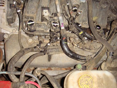 1992 Ford Bronco - Engine bay details with numerous electrical connectors and hoses visible, along with a SuperMotors logo.
