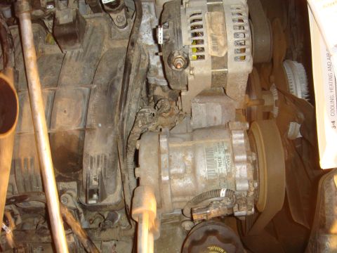 1992 Ford Bronco - Close-up view of a vehicle's engine compartment, showing various mechanical components and wiring.