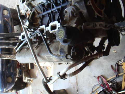 1992 Ford Bronco - Close-up view of an engine assembly, showing various hoses and mechanical components.