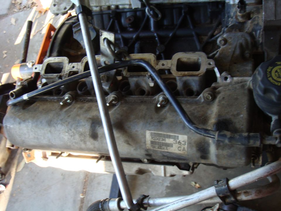 Engine block with visible part numbers and hoses