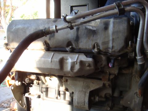 1992 Ford Bronco - Engine part detail, likely from a Ford vehicle, with visible hoses and connectors.