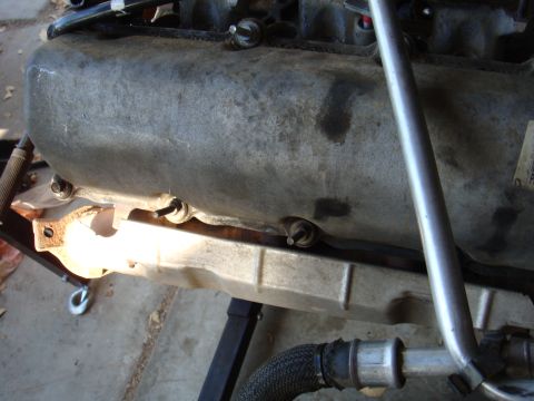 1992 Ford Bronco - This image shows a close-up view of an engine's oil pan and surrounding components, likely during maintenance or repair.