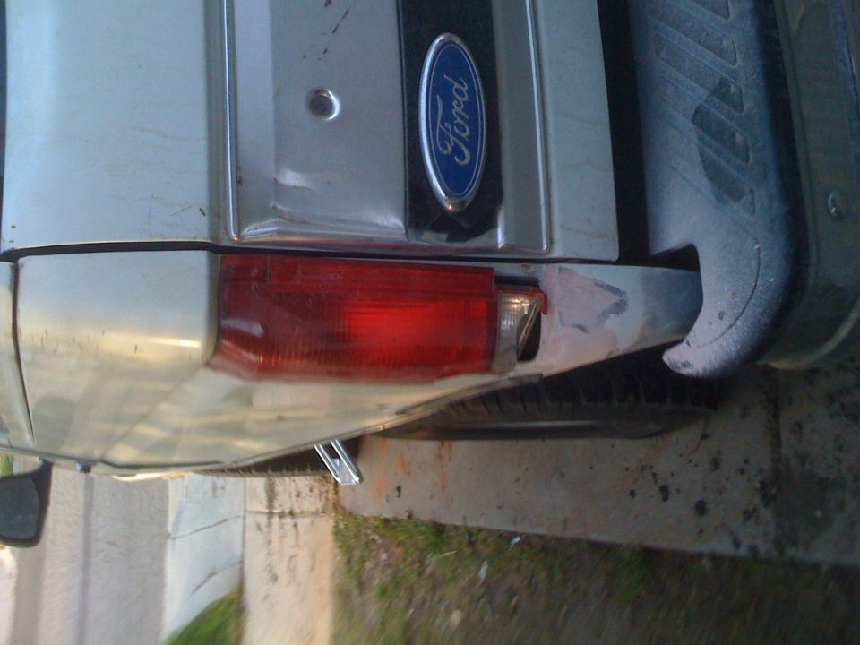 Silver SUV rear with Ford emblem and red taillight. Matches 1992 Ford Bronco