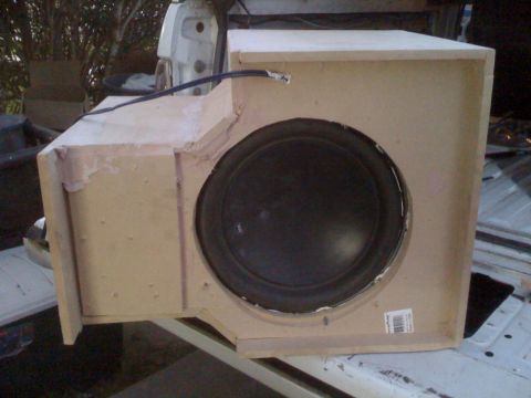 1992 Ford Bronco - A custom-built speaker box with a subwoofer is shown, with unfinished wood construction and visible wiring.