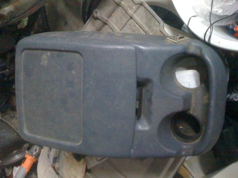 1992 Ford Bronco - This is a vehicle interior part, possibly a center console, with a flip-up compartment and cup holders.