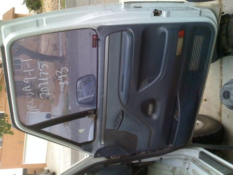 1992 Ford Bronco - The interior door panel and window of a vehicle show handwritten text and numbers on the glass.