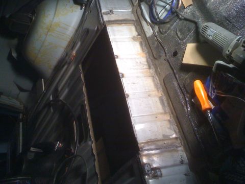 1992 Ford Bronco - Metal floor panel repair in progress, with tools and equipment visible.
