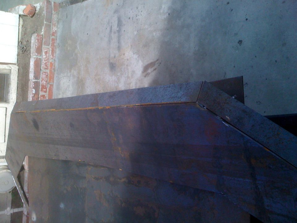 rusted metal fabrication with sharp angles and visible seams