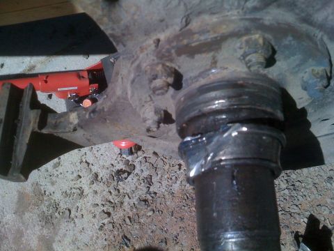 1992 Ford Bronco - Close-up view of a vehicle's suspension system, showing mechanical components and grease.