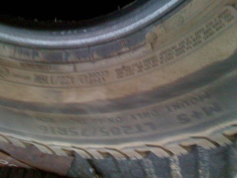 1992 Ford Bronco - Close-up of a tire sidewall showing size information and other text.