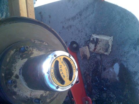 1992 Ford Bronco - Close-up of a chrome Warn locking hub with yellow insert, indicating 'LOCK' and 'FREE' positions.