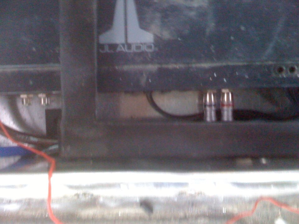 JL Audio logo on a black panel with RCA connectors and wiring visible