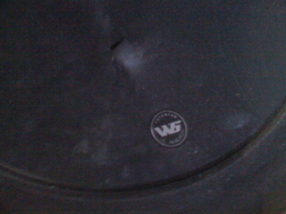Dark gray wheel with a circular WG logo badge