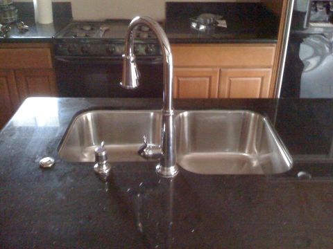 1992 Ford Bronco - Kitchen sink area with granite countertop, chrome faucet, and stainless steel basins.
