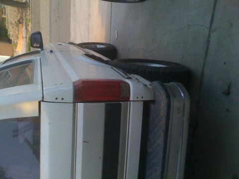 1992 Ford Bronco - This white SUV appears to be a 1992 Ford Bronco, viewed from the rear with a spare tire mounted.