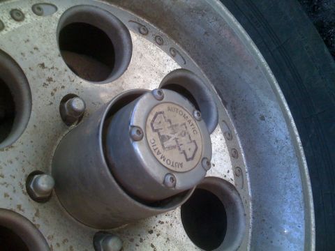 1992 Ford Bronco - This image shows a close-up of a vehicle's wheel hub, an 'AUTOMATIC 4X4' emblem.