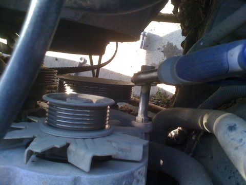 1992 Ford Bronco - This photo shows a close-up view of the engine's belt system, focusing on the tensioner pulley and surrounding components.