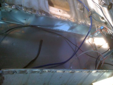 1992 Ford Bronco - The interior of a vehicle displays exposed metal and electrical wiring, suggesting modifications or repairs.