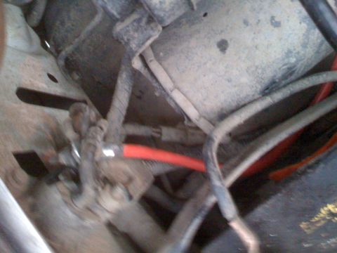 1992 Ford Bronco - Underside view of vehicle wiring and a red hose, details unclear.