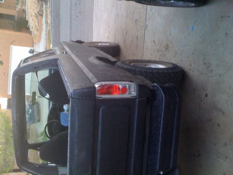 1992 Ford Bronco - Rear view of a black 1992 Ford Bronco with a spare tire on the tailgate.