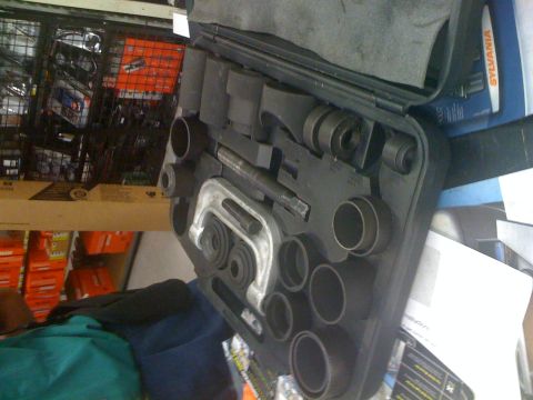 1992 Ford Bronco - A ball joint press tool kit is shown in its case, with various sockets and a C-clamp style press.