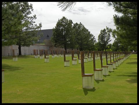 1998 Subaru Legacy - The Oklahoma City National Memorial features numerous empty chairs arranged in rows on a green lawn.