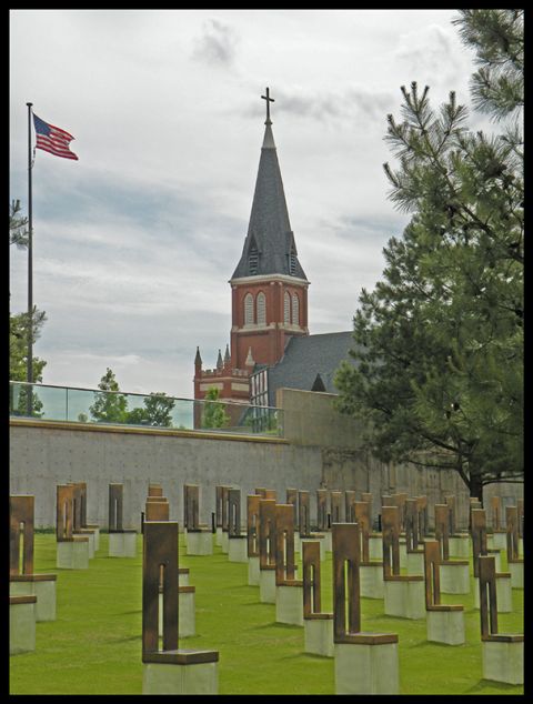 1998 Subaru Legacy - The Oklahoma City National Memorial features rows of chairs on a grassy field, with a church steeple in the background.